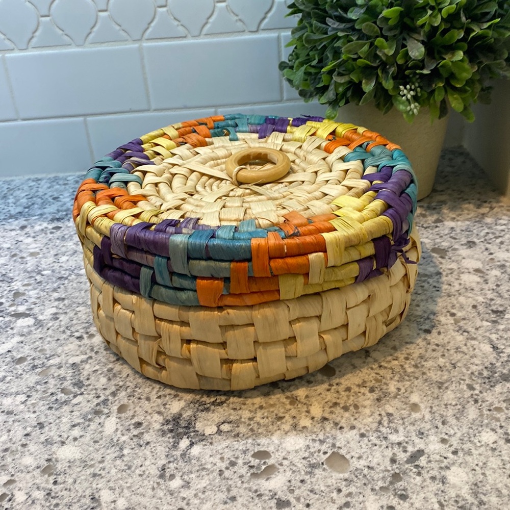 Colorful hand woven basket with wood ring handle